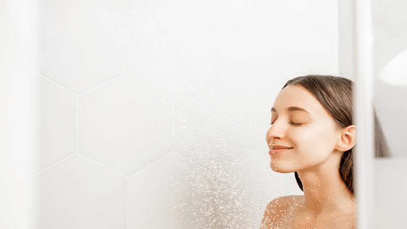 happy woman in shower benefiting reduced depression