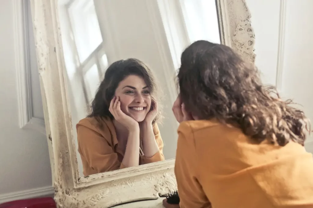 lady looking into mirror trying to reconnect with self