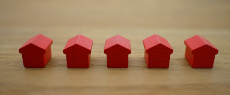 monoply houses in a row representing investments in property