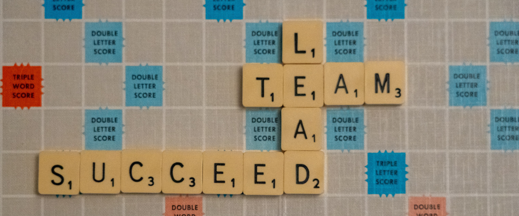 scrabble board with team success and leadership styles